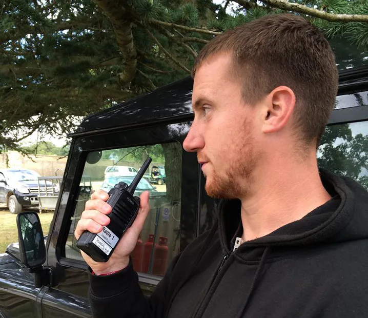 Crew member using a handheld two-way radio